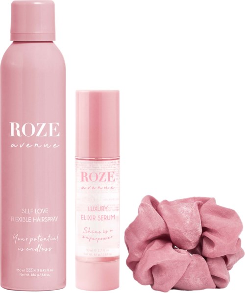 Rosa Haarpflegeprodukte und ein pinkes Haargummi auf weißem Hintergrund.
