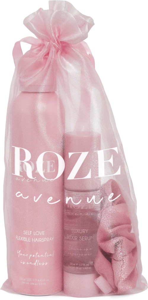 Rosa Geschenktasche mit Haarspray, Serum und Handtuch. Die Tasche hat den Text 'REZE avenue'.