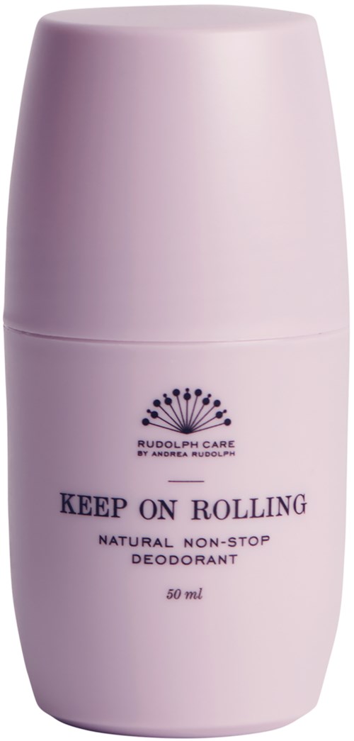 A small, light pink deodorant container with the text "KEEP ON ROLLING" and a crown logo.