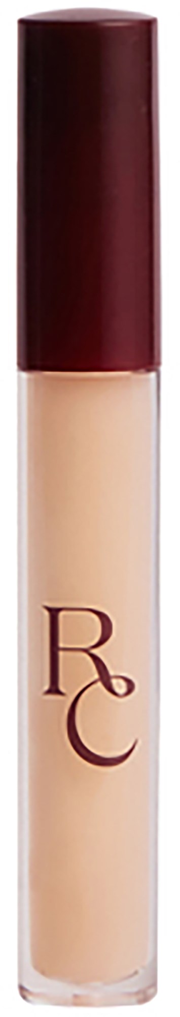 En beige flytande concealer i en klar tub med en mörkröd topp, märkt med bokstäverna 'RC'.