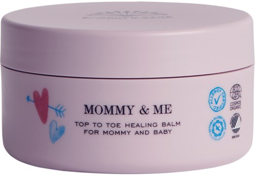 A pink round jar with hearts, labeled 'Mommy & Me' healing balm for moms and babies, featuring certification symbols.