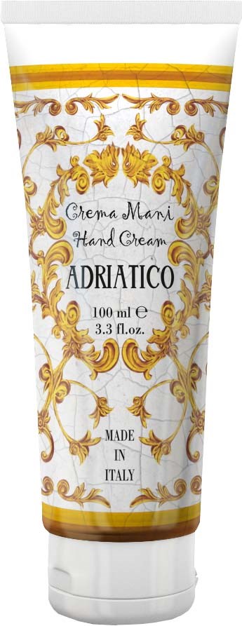 A white tube of hand cream decorated with gold patterns, label says 'Crema Mani Hand Cream' from Adriatico, made in Italy.