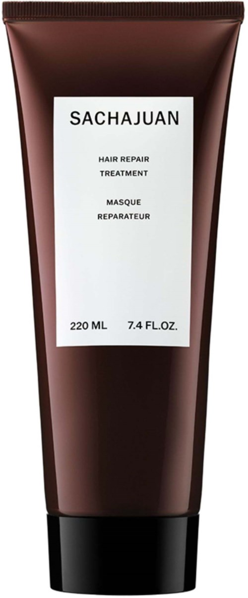 Braune Tube mit weißem Etikett, das Haarreparaturbehandlung und Volumenangaben enthält.