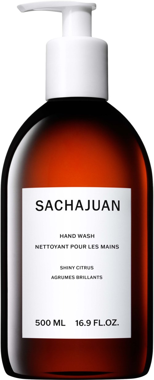 A dark amber bottle with a white pump, labeled "Sachajuan" hand wash, infused with shiny citrus scent, 500 ml.