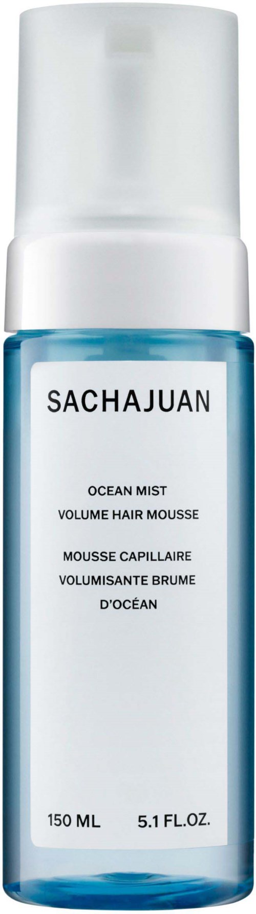 A blue spray bottle labeled 'SACHAJUAN' with white cap, containing ocean mist for hair volume.