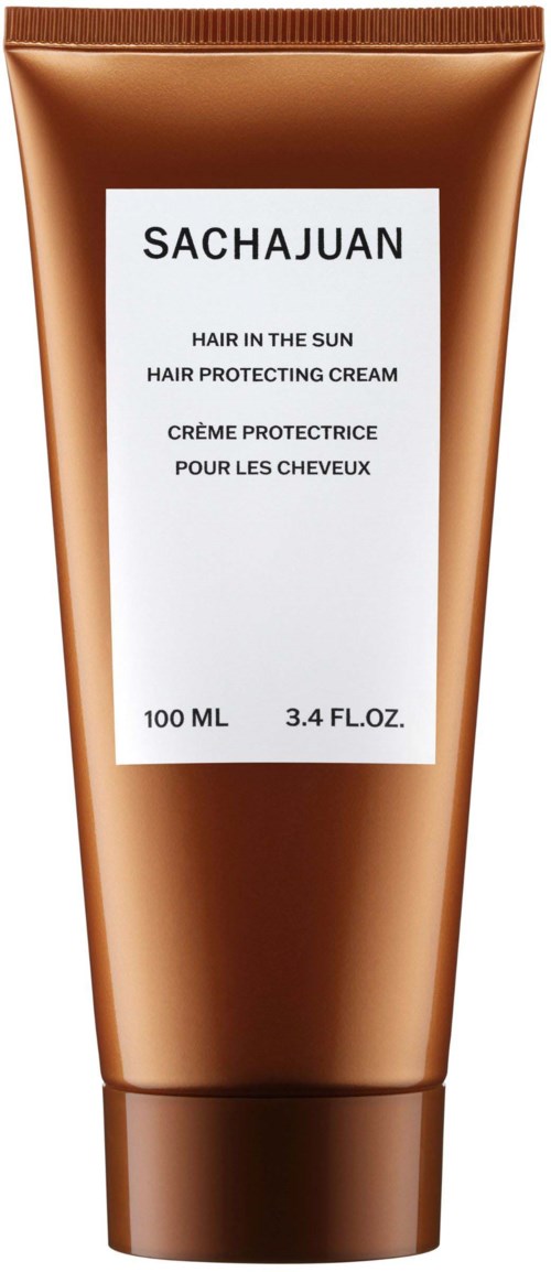 Ein brauner Tube mit Sachajuan-Haarschutzcreme und weißem Etikett mit Produktinformationen.