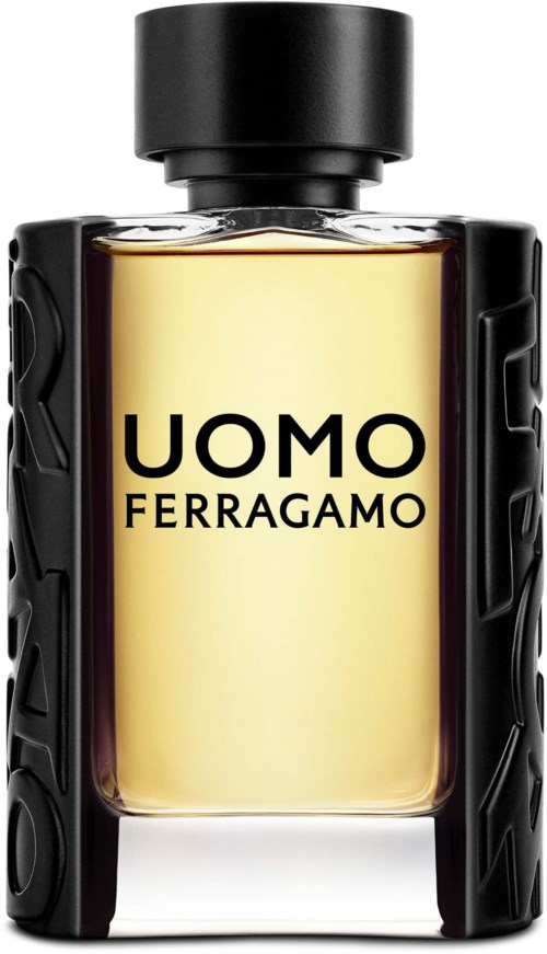 Hajuvesipullo nimeltä UOMO FERRAGAMO musta korkilla ja mustat ruudulliset sivut, sisältää vaaleankeltaista hajuveden.