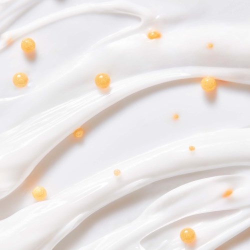 Weiße Creme-Wellen mit kleinen orangefarbenen Kugeln verstreut, schaffen ein schlichtes, glattes Design.