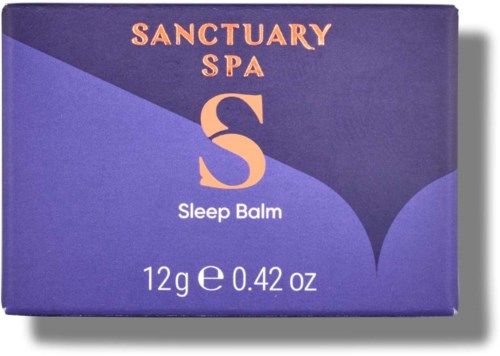 Eine lila Verpackung mit orange- und weißem Text über Sanctuary Spa Sleep Balm, wiegt 12 Gramm oder 0,42 Unzen.