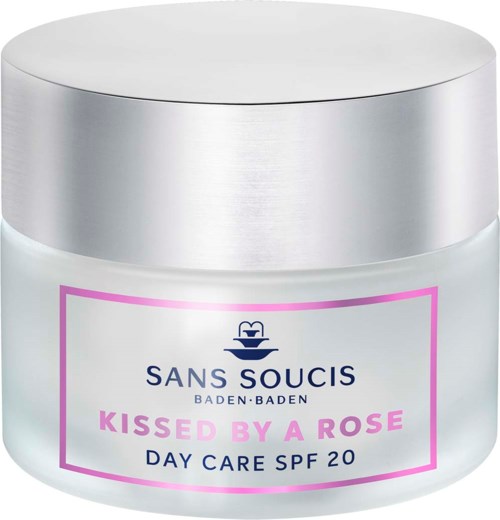 A white jar with a silver lid, pink and blue label, water fountain icon, and text about day care sunscreen SPF 20.