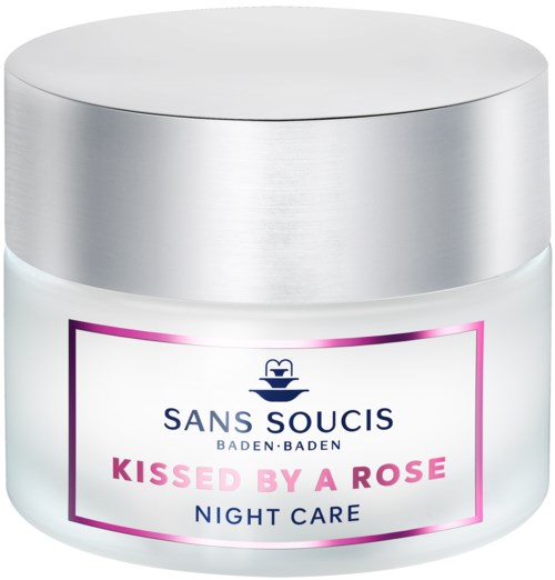 A white jar with purple and black text promoting night care cream, labeled 'Kissed by a Rose.'