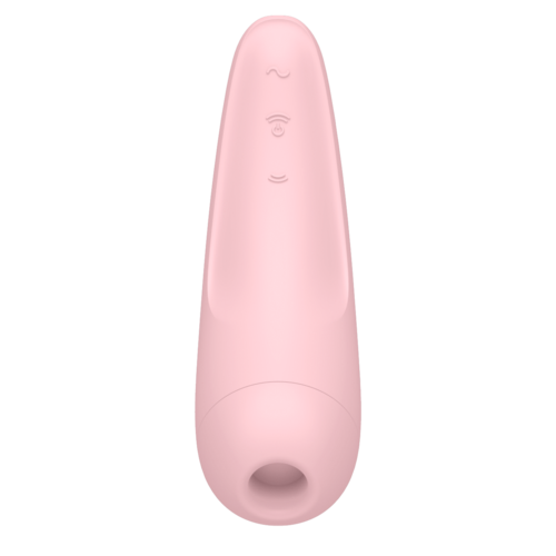 A pink device with a simple face design, rounded top, and a hole at the bottom.