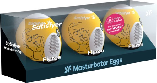 Tre gula ägg med ansiktsillustrationer och etiketter, placerade i en tydlig låda märkt "Masturbator Eggs".