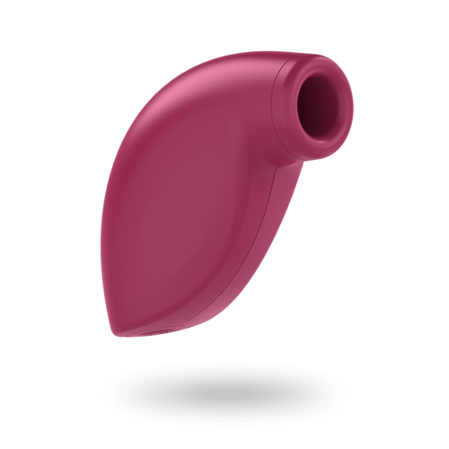 A pink, small, handheld object with a rounded opening, likely a microphone or small electronic device.