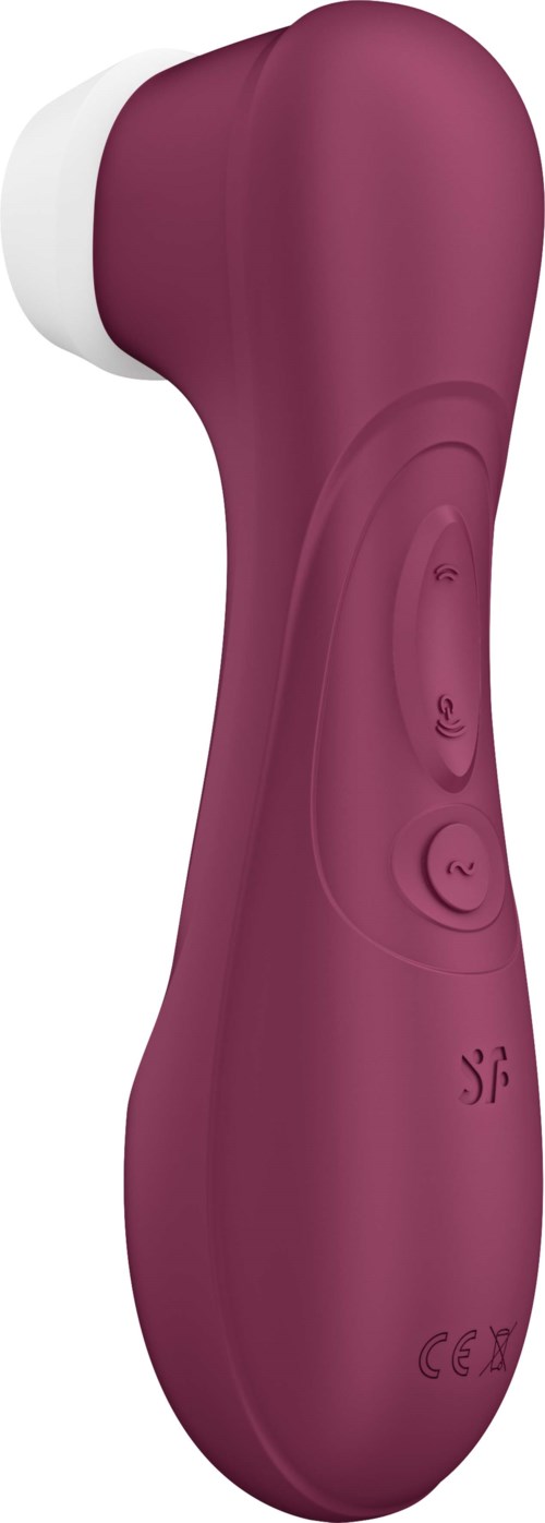 A pink handheld device with buttons, likely a facial or skin cleaning brush.