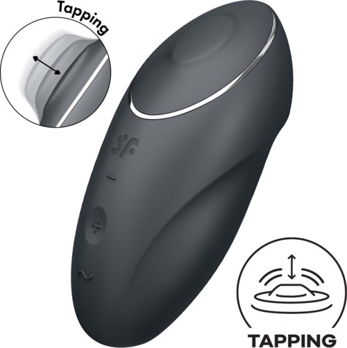 A black gadget with a large circular top, tapping area, and buttons for adjustment. It likely helps with relaxation or heating.