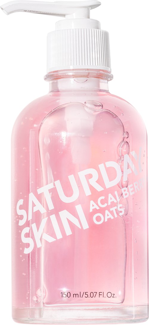 Roze doorzichtige fles met witte pomp, gelabeld 'SATURDAYS SKIN' en 'ACAI BERRY OATS.'