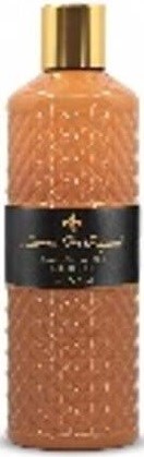 A peach-colored bottle with a gold cap and a black label. The bottle has a textured surface with small dots.