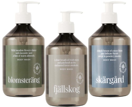 Three bottles of body wash with different scents and labels, in brown bottles with white pump caps.