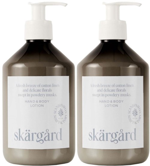Zwei Flaschen Hand- und Körperlotion mit weißen Pumpen und schlichten Etiketten. Die Lotion hat einen Baumwoll- und Blumen Duft.