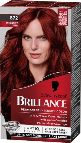 Vrouw met rood haar op haarverfdoos, glimlachend, met productdetails en merknaam Schwarzkopf Brilliance.