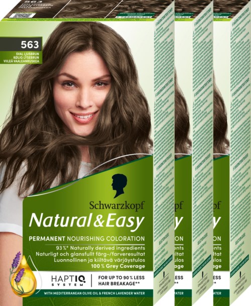 Kartonschachteln mit einem lächelnden Frau mit langen, gewellten braunen Haaren auf der Vorderseite, Etiketten mit grün und weiß, Produktinformationen und Logo.