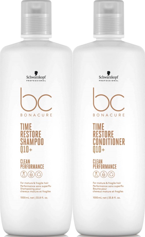 Twee witte flessen haarverzorgingsproducten voor shampoo en conditioner, met zwarte en gouden tekst, staan naast elkaar.