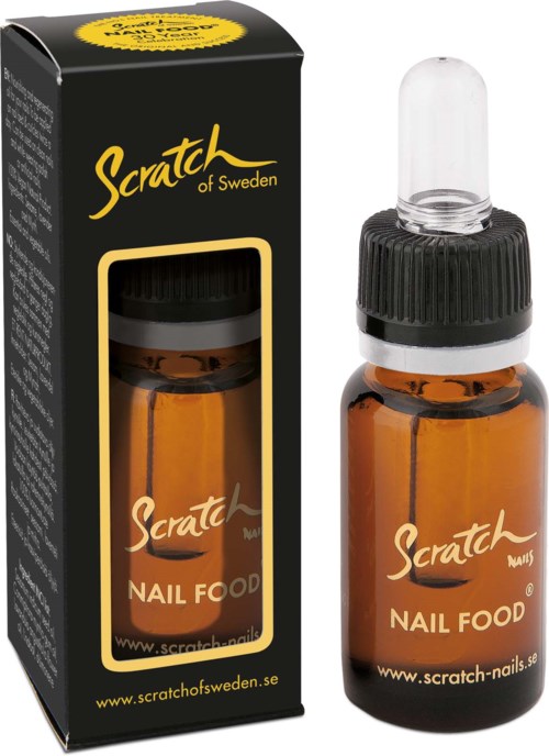 Saviinvärinen lasipullo tipparuuvilla, merkintä "Scratch Nail Food," sen musta laatikkopakkaus.