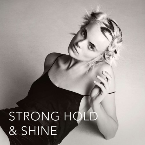 Een vrouw met gestyleerd haar en een zwarte top kijkt zelfverzekerd naar de camera. Tekst zegt: "Strong Hold & Shine."