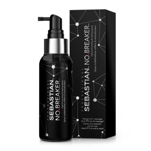 Eine schwarze Sprühflasche mit weißem Etikett und silberner Kappe, neben einer passenden Box.