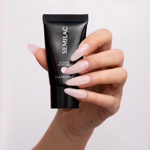A hand with long, light pink nails holds a black tube labeled SEMILAC, which is a pink gel product.