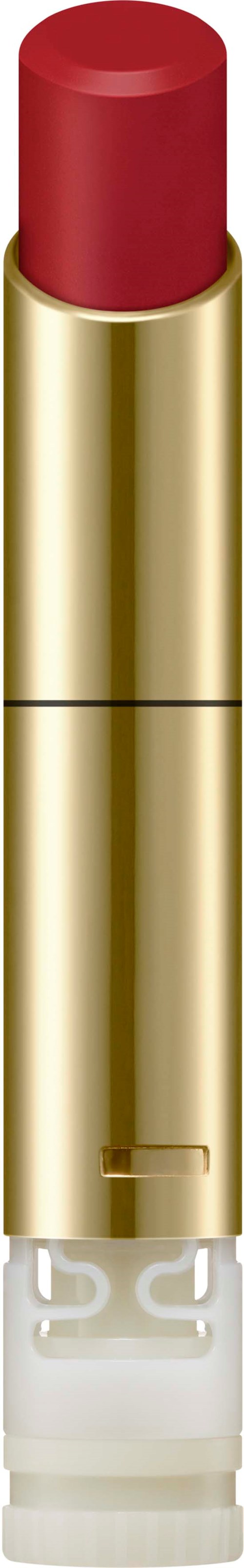 A red lipstick in a gold tube. The lipstick is slightly extended from the tube.