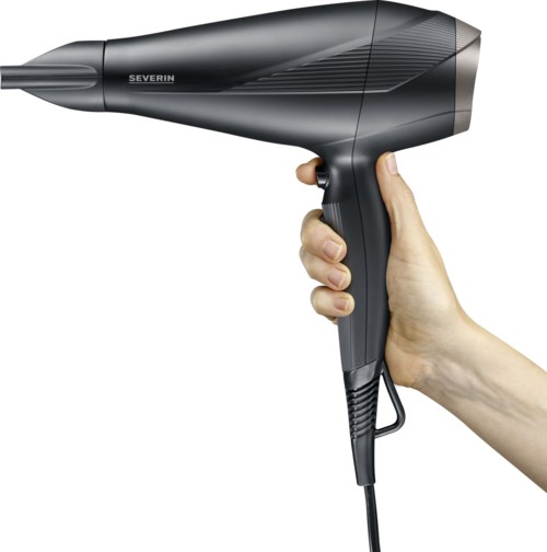 A hand holding a black hair dryer with a brand name on it, pointing to the left.