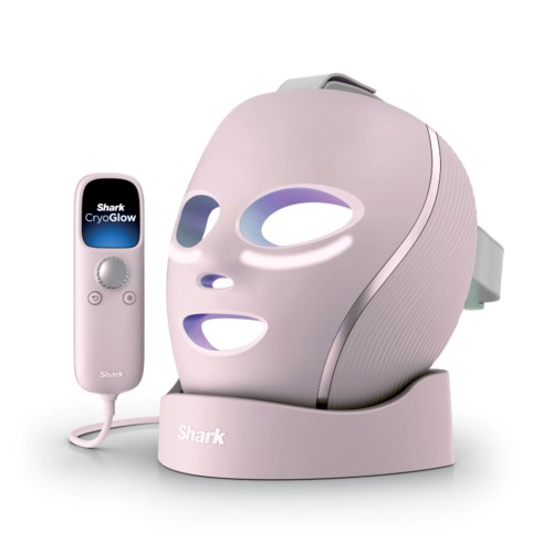 A facial mask device with LED lights and a remote control on a stand, used for skin care treatments.