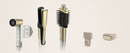 A collection of hair styling tools including a hair dryer, flat iron, round brush, and attachment pieces.