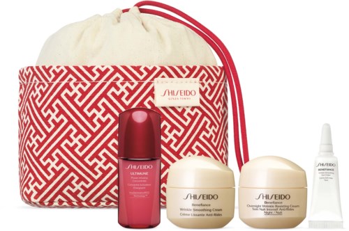 Skincare set with creams, serum, and a red patterned bag for travel or daily use.