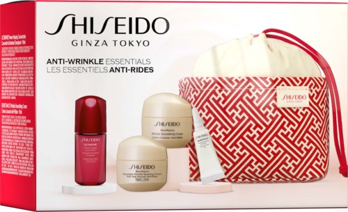 Box with skincare products and a red and white bag. The products include a red bottle and two cream jars.