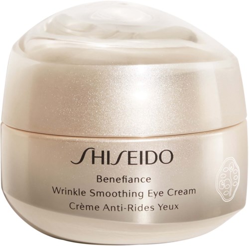 En rund burk med Shiseido Benefiance Wrinkle Smoothing Eye Cream i guld- och silvernyanser.