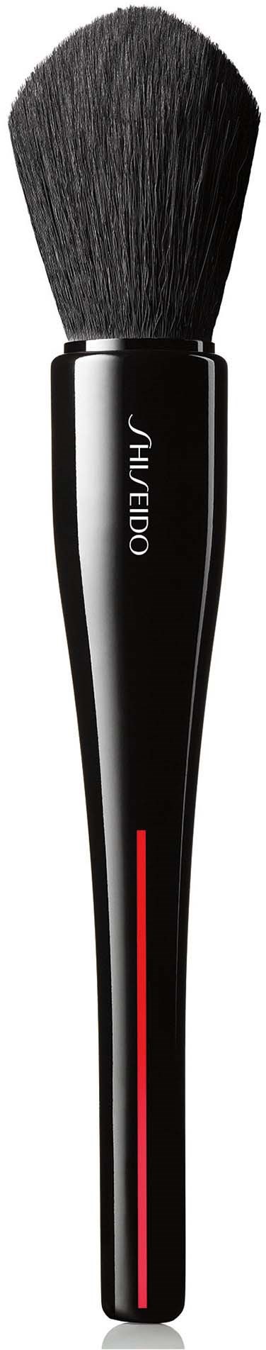 A black makeup brush with a rounded top and a red line on the handle.