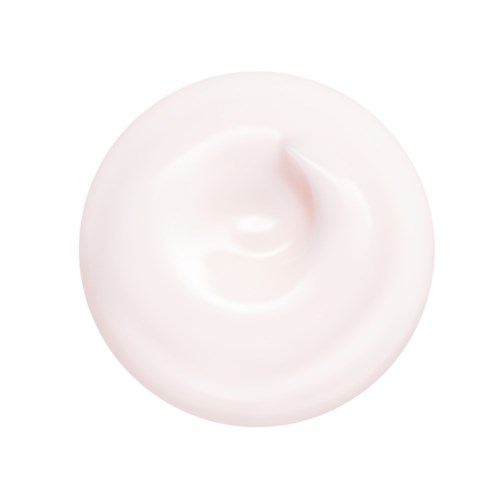 En vit kräm eller lotion på en vit yta, med en liten topp i mitten.