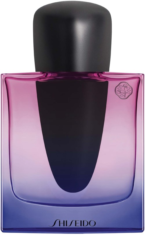 En doftflaska med a gradient av rosa och lila, med en svart kork. Varumärket är Shiseido.