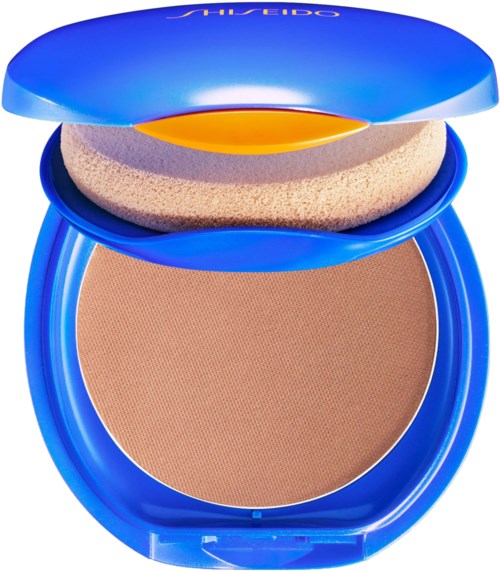 A blue compact with a beige powder and an applicator sponge inside the lid.