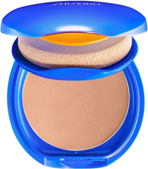 A compact blue makeup case with a sponge and beige powder inside, open to show its contents.
