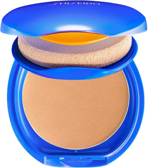 Blue compact with beige powder, sponge applicator inside, lid open. Shiny blue packaging and brand name on lid.