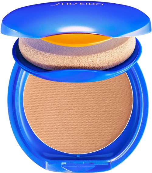 Ett kompakt, blått, runt makeup-produkts med spegel, sponge och beige pudergrund.