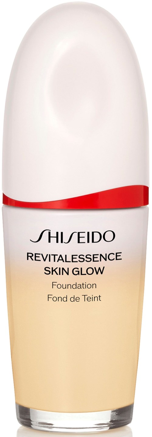 A white bottle with red and gold accents contains Shiseido RevitalEssence Skin Glow Foundation.