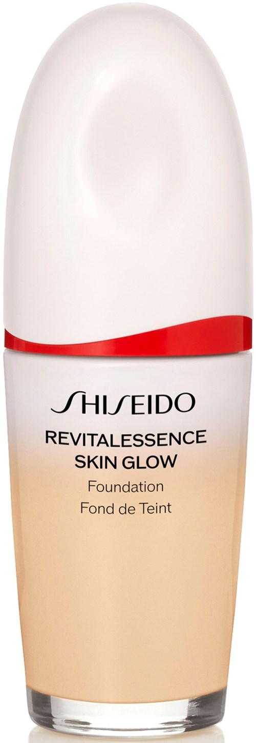 Shiseido Revitalescence Skin Glow foundation flaska, vit med röda och beige detaljer.