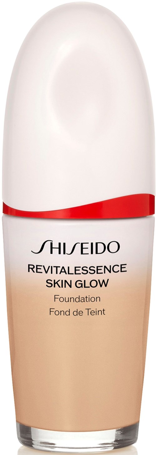 A bottle of Shiseido foundation with a white cap and a beige liquid inside, labeled 'Revitalessence Skin Glow' and 'Foundation.'