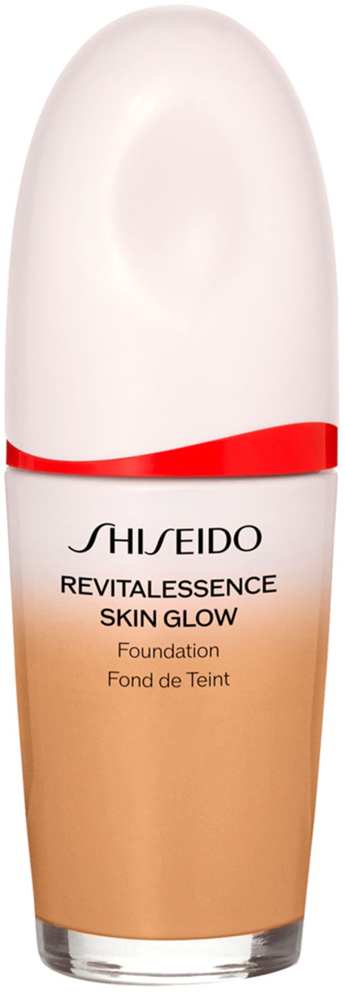 En flaska av Shiseido Revitalessence Skin Glow foundation med vit lock och en röd linje.