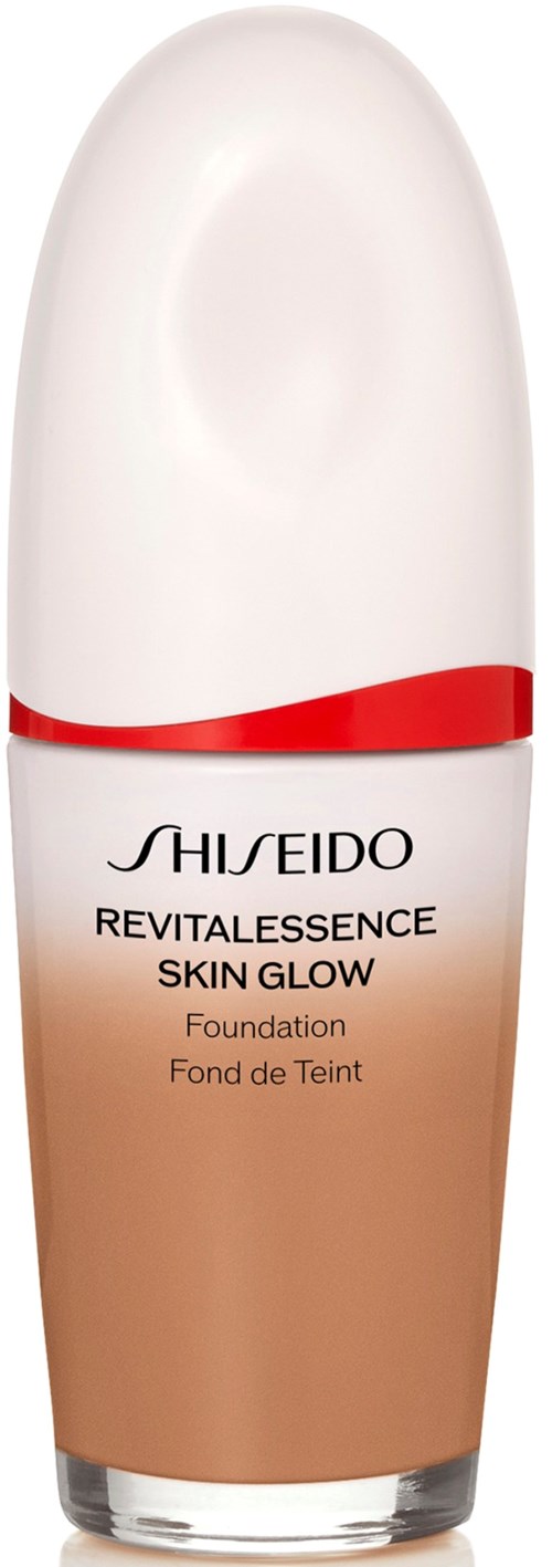 A bottle of Shiseido Revitalessence Skin Glow foundation with a white cap and a beige body.